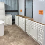 White raised-panel bathroom vanities displayed in a showroom | Jabara's